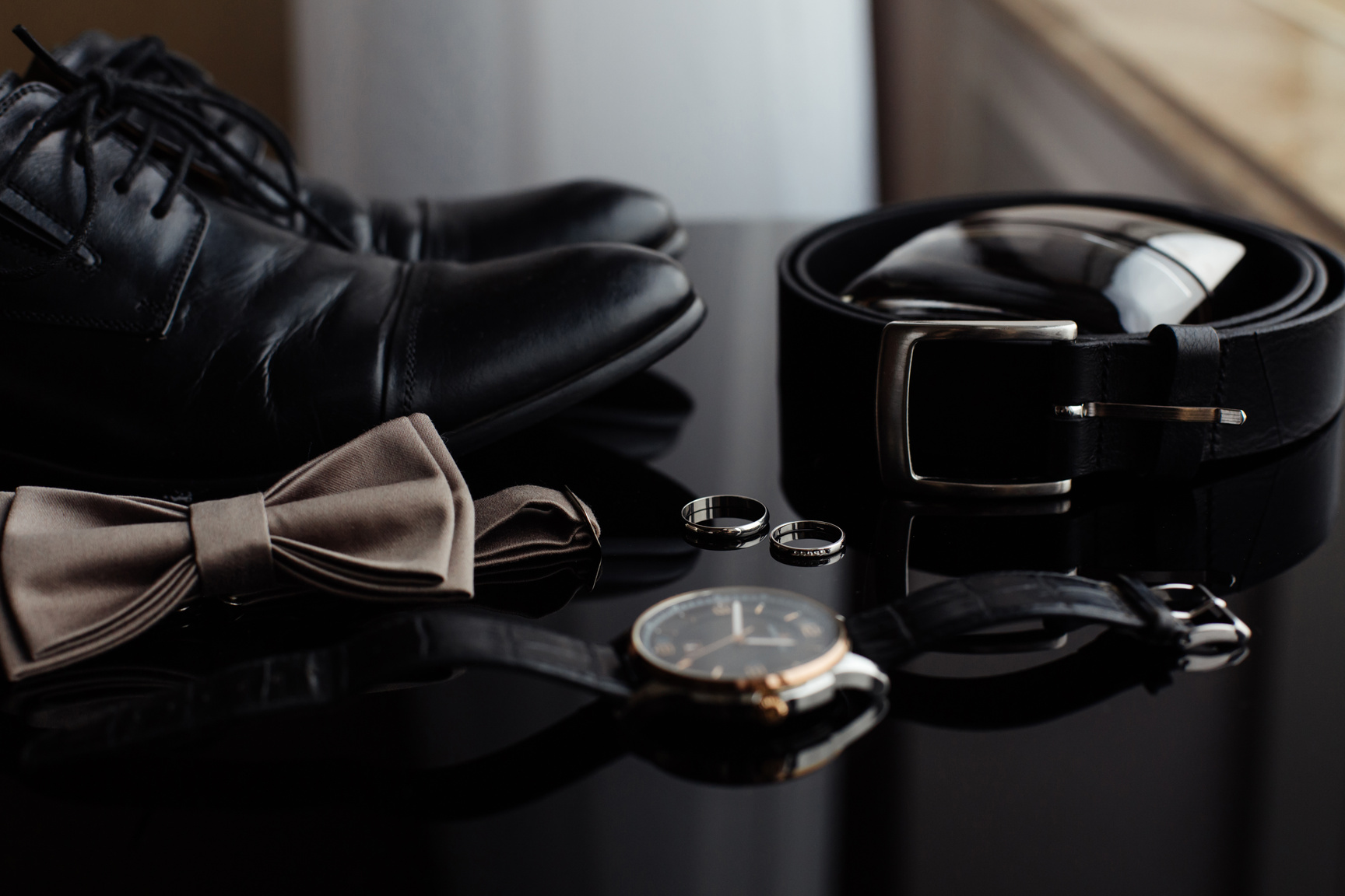 Wedding grooms accessories on black table.